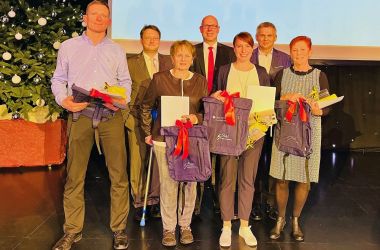 Männer und Frauen stehen auf einer Bühne anlässlich einer Sportlergala.