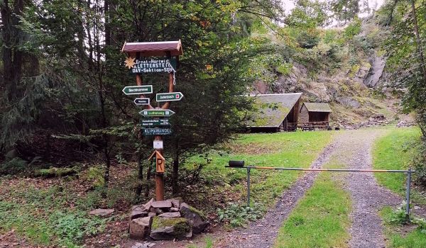 Ein Wegweiser in einem Wald.