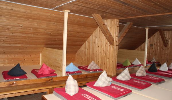 Ein Mehrbettenzimmer in einer Berghütte.