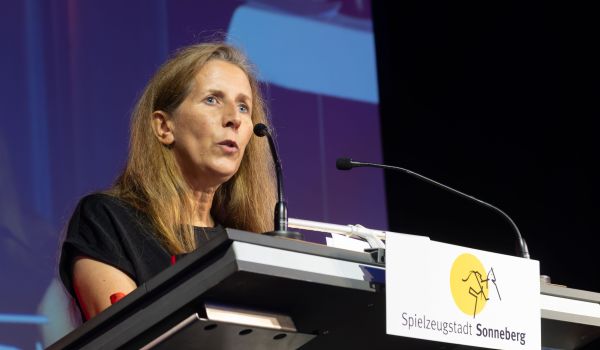 Eine Frau steht hinter einem Rednerpult.